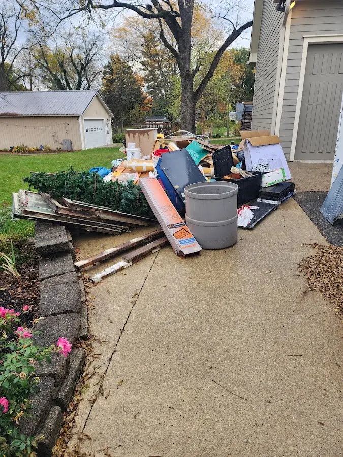 Dumpster being loaded with debris for 10 Yard Dumpster Rental in West Liberty